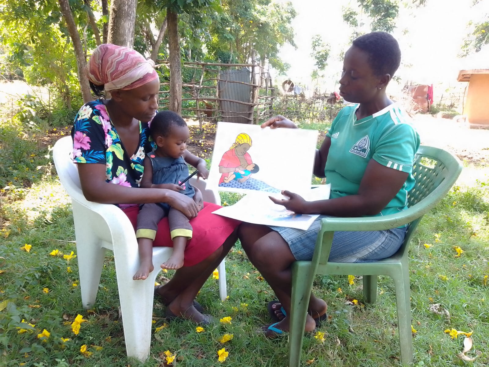 Pius Ochieng, a 60-year-old father, playing with his baby Esther, showing strong male engagement.